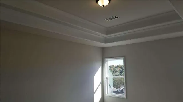 a view of a livingroom with a ceiling fan and window