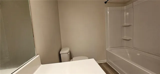 a bathroom with a bathtub and toilet