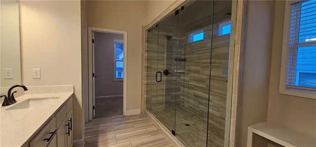 a bathroom with a shower and a sink