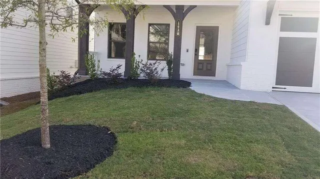 a front view of a house with garden