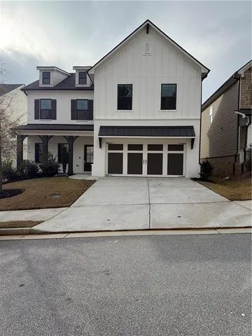 a view of swimming pool with outdoor seating and yard in front of it