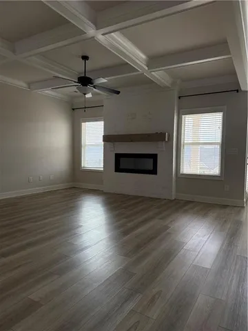 a kitchen with stainless steel appliances a stove top oven a sink dishwasher and a refrigerator with wooden floor