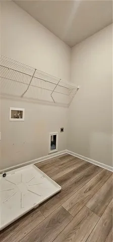 a view of a room with wooden floor