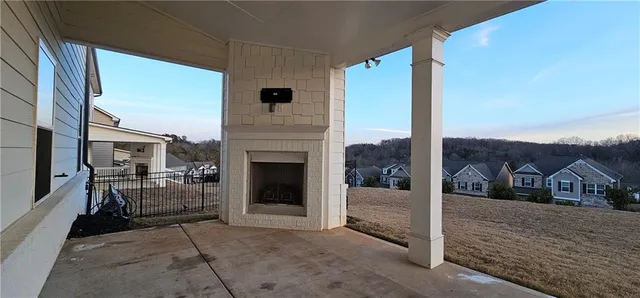 a view of a porch with furniture and a fireplace