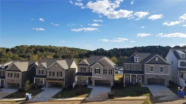 a view of a town with brick building and large tree