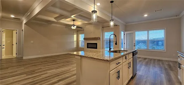 a view of living room with kitchen island furniture and wooden floor