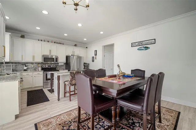 a kitchen with stainless steel appliances a stove microwave and refrigerator