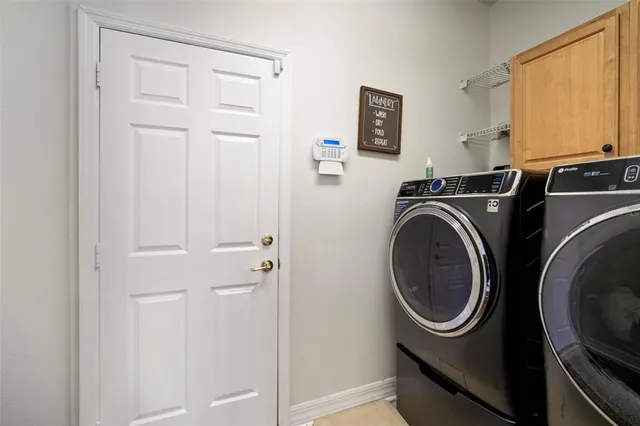 a view of a house with a yard and a tree