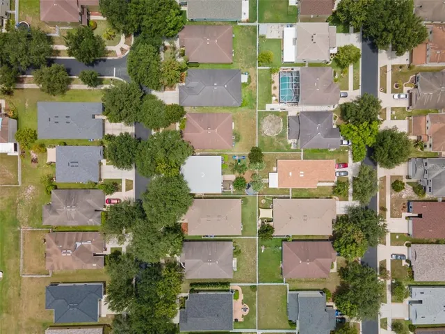 an aerial view of residential houses with outdoor space