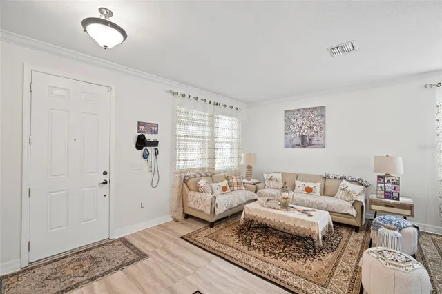 a living room with furniture wooden floor and a table