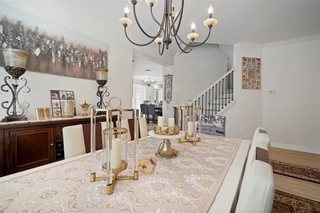 a living room with furniture chandelier and a dining table