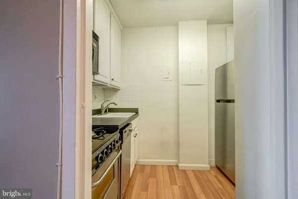a kitchen with stainless steel appliances granite countertop a sink stove and microwave