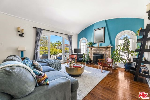 a living room with furniture fireplace and window