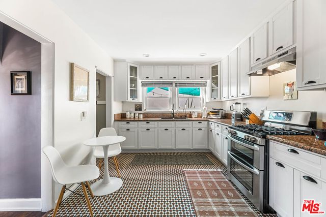 a kitchen with a stove a sink and a refrigerator