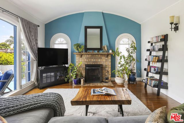 a living room with furniture a flat screen tv and a fireplace