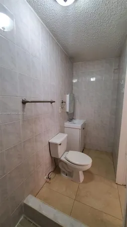 a bathroom with a toilet a sink and a shower