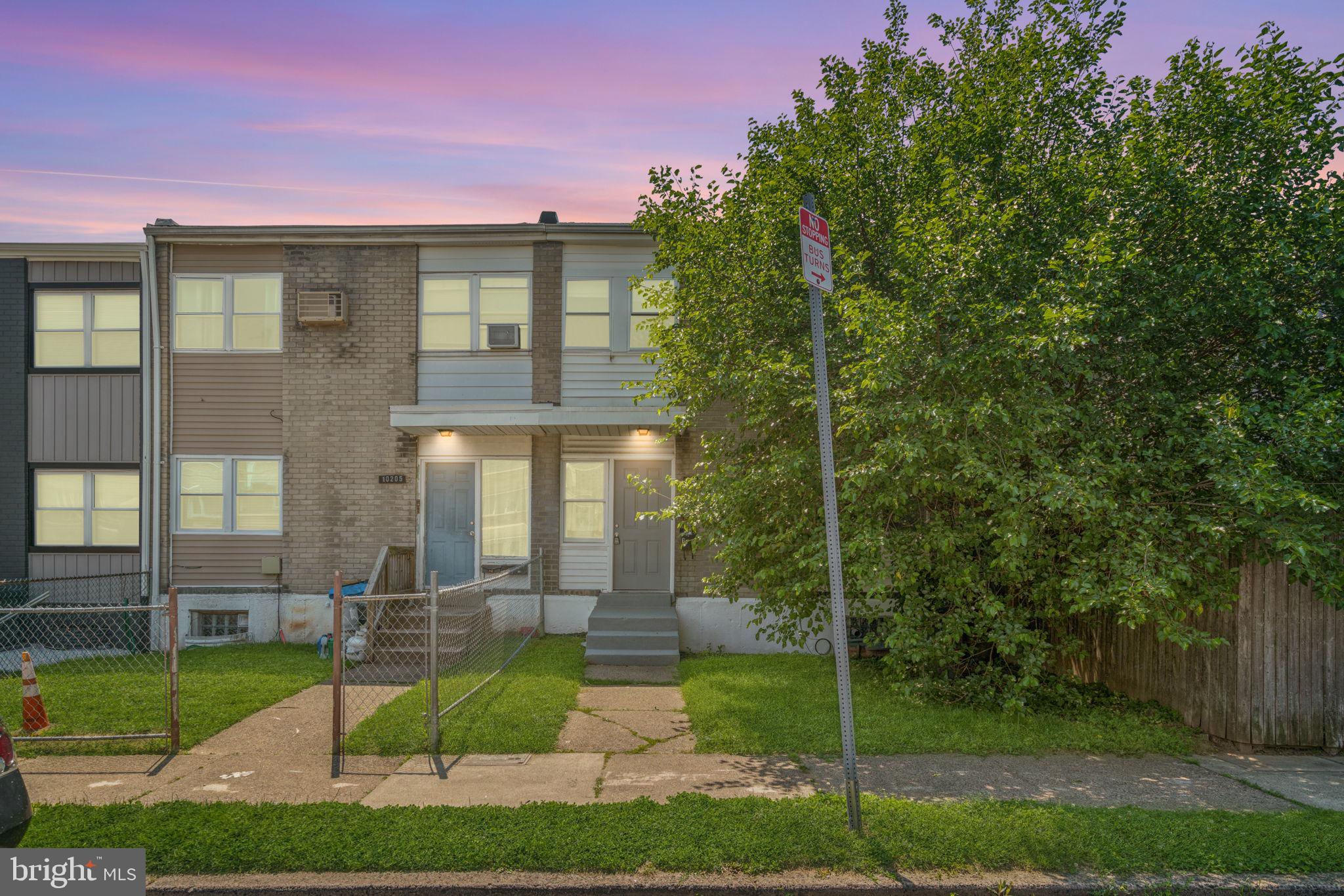 10203 East Keswick Road, Unit 1 Philadelphia, PA 19114 - Photo 1 of 23 a view of a brick house next to a yard with big trees