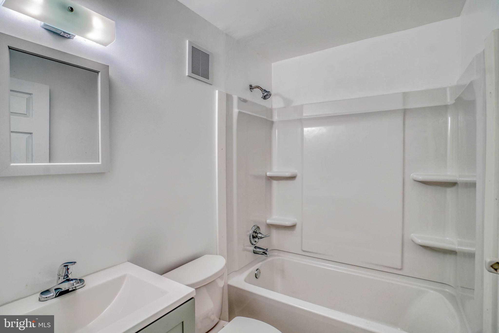 10203 East Keswick Road, Unit 1 Philadelphia, PA 19114 - Photo 14 of 23 a bathroom with a sink a toilet and shower