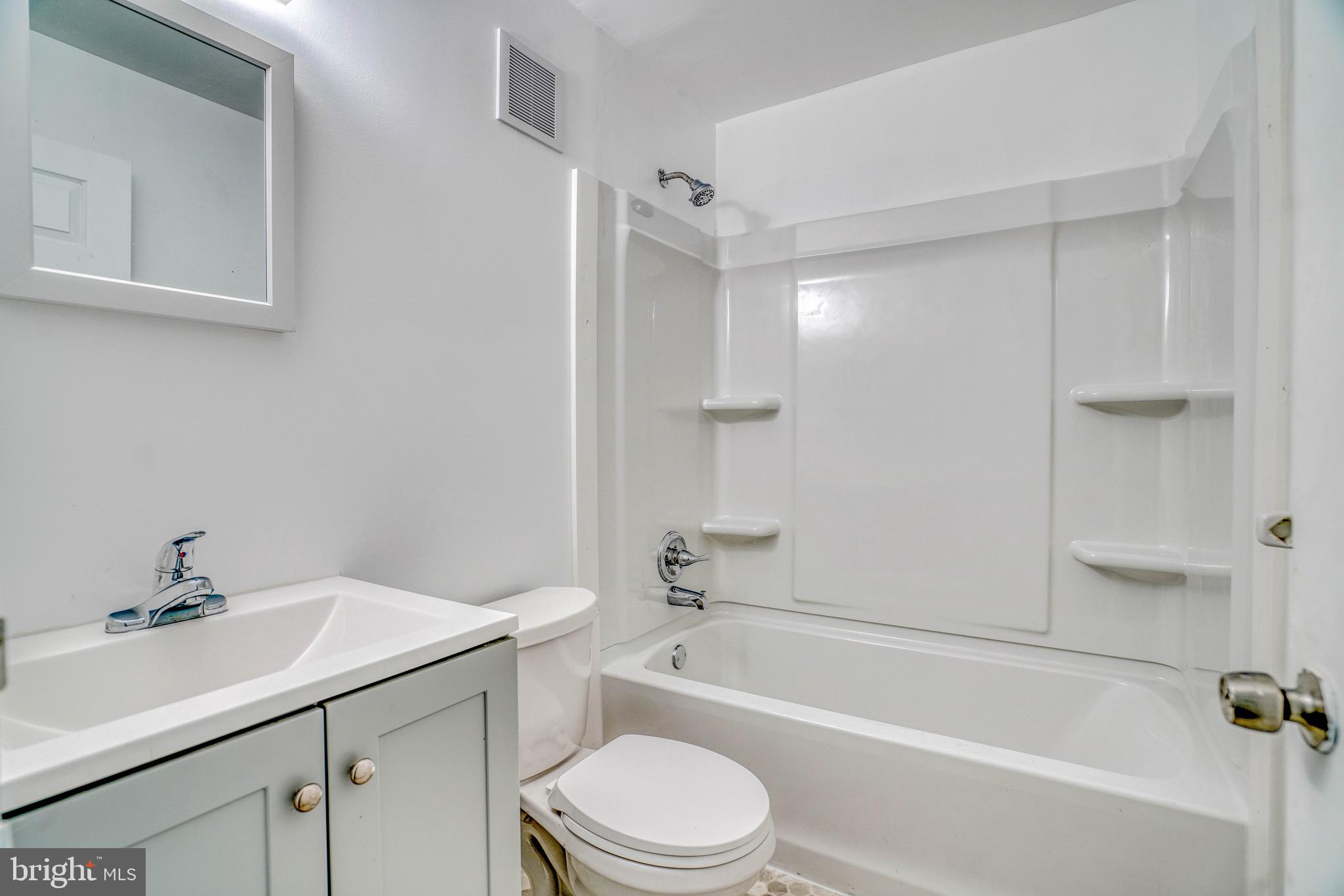 10203 East Keswick Road, Unit 1 Philadelphia, PA 19114 - Photo 15 of 23 a bathroom with a sink toilet and bathtub