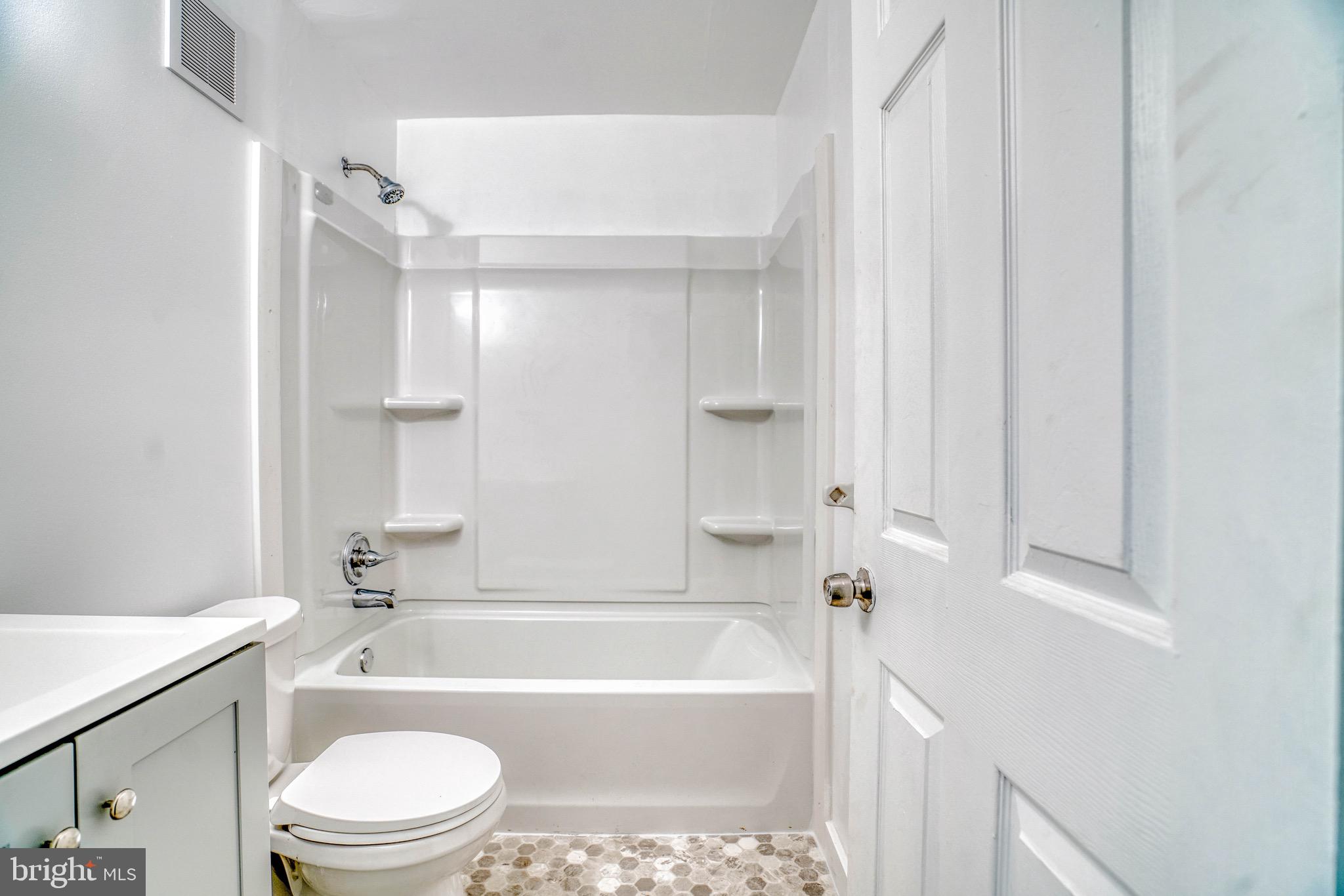 10203 East Keswick Road, Unit 1 Philadelphia, PA 19114 - Photo 16 of 23 a bathroom with a bathtub shower sink vanity and toilet