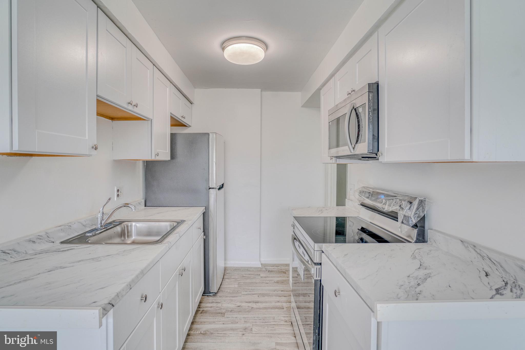 10203 East Keswick Road, Unit 1 Philadelphia, PA 19114 - Photo 6 of 23 a kitchen that has a sink and a stove in it