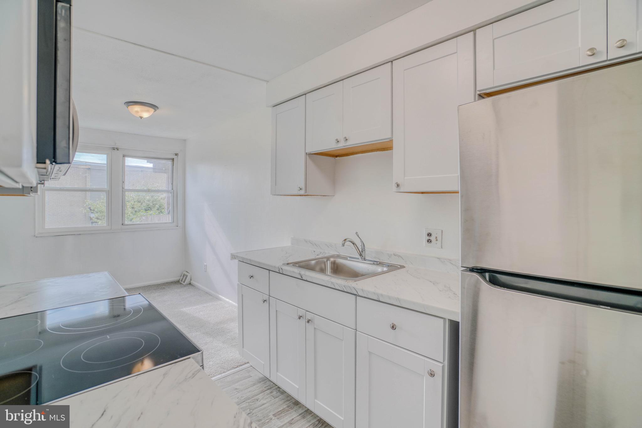 10203 East Keswick Road, Unit 1 Philadelphia, PA 19114 - Photo 10 of 23 a en suite bathroom with a granite countertop sink and a toilet