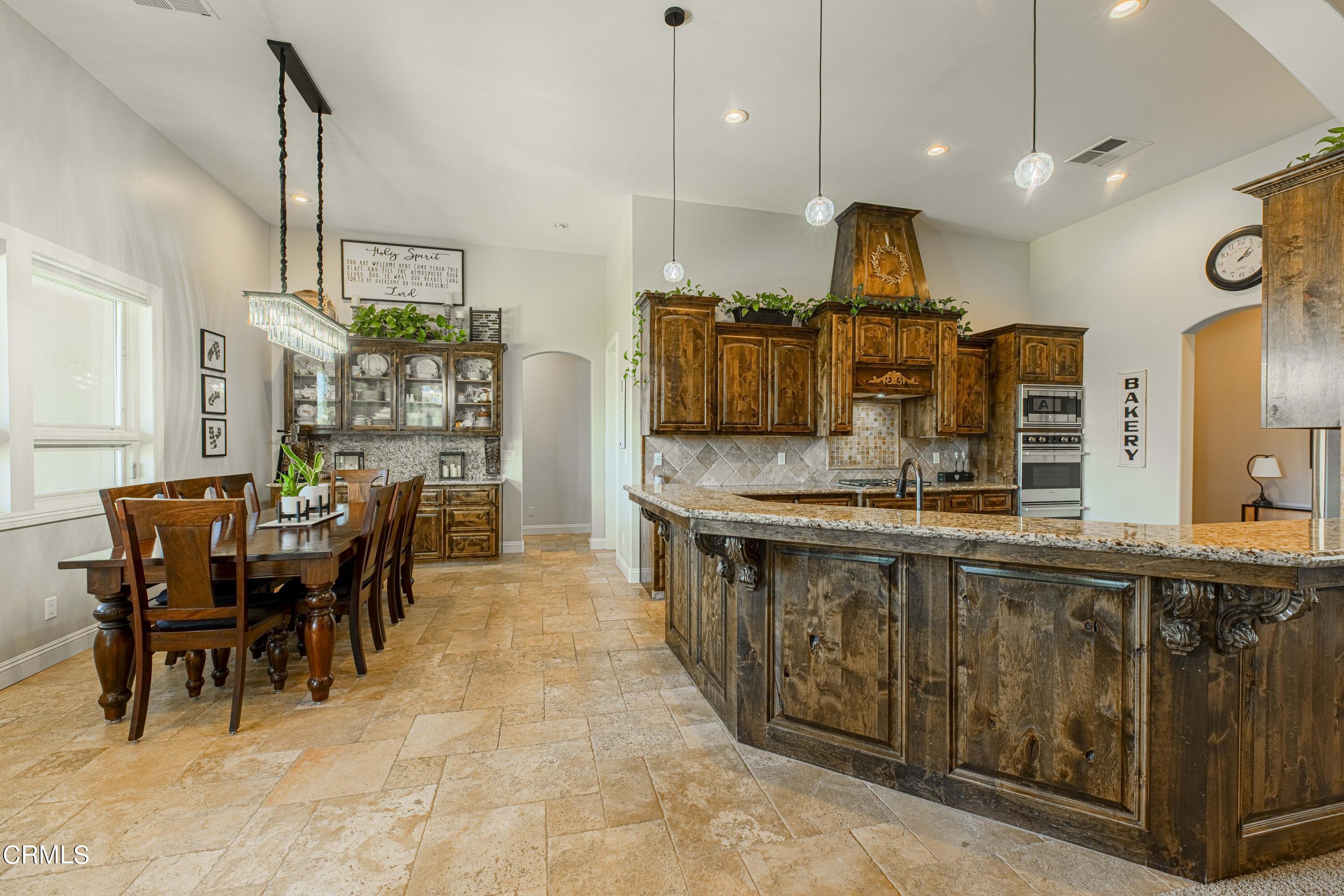 15023 Redwood Pass Drive Bakersfield, CA 93314 - Photo 15 of 67 a kitchen with kitchen island granite countertop lots of counter top space