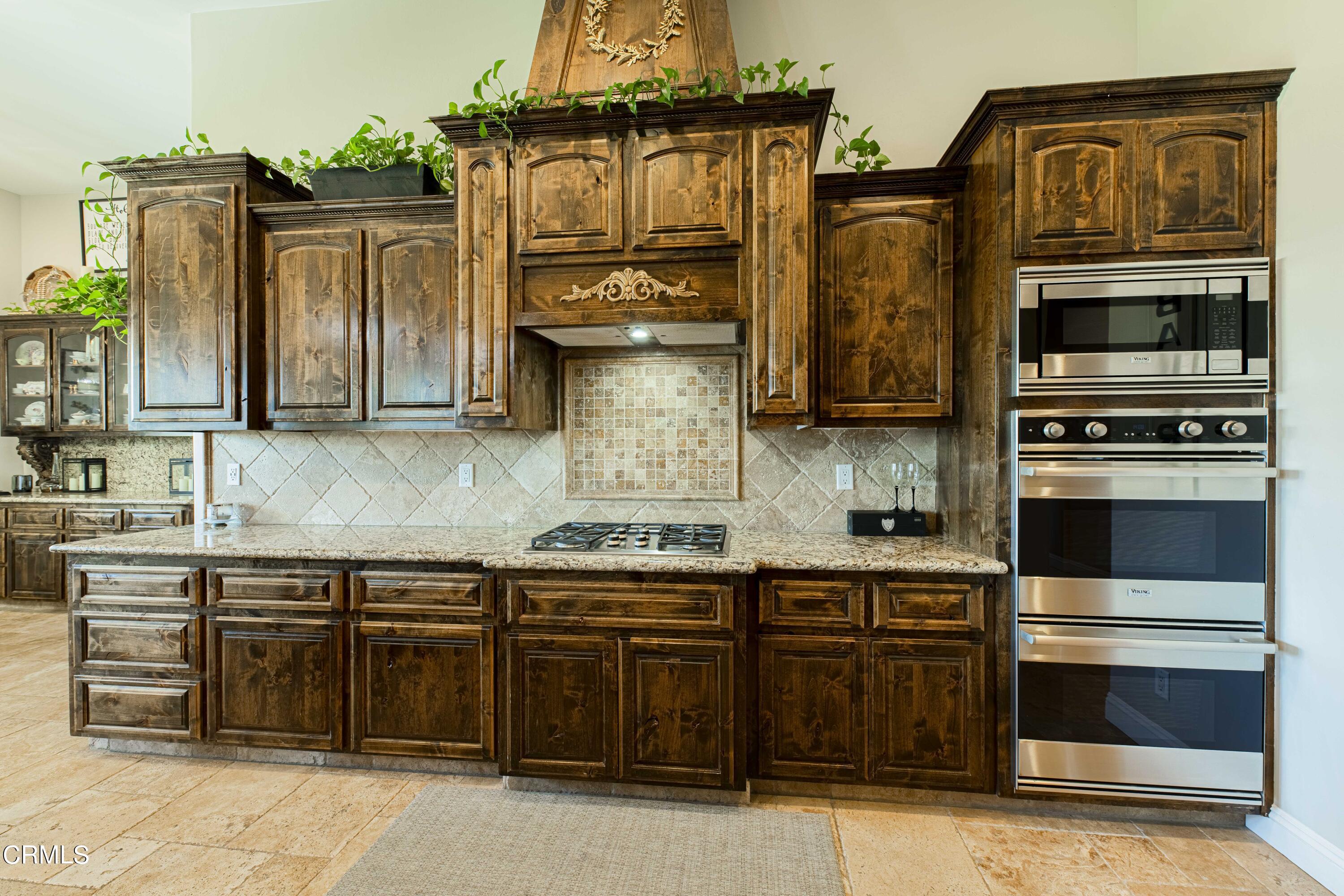 15023 Redwood Pass Drive Bakersfield, CA 93314 - Photo 22 of 67 a kitchen with stainless steel appliances granite countertop a stove and cabinets