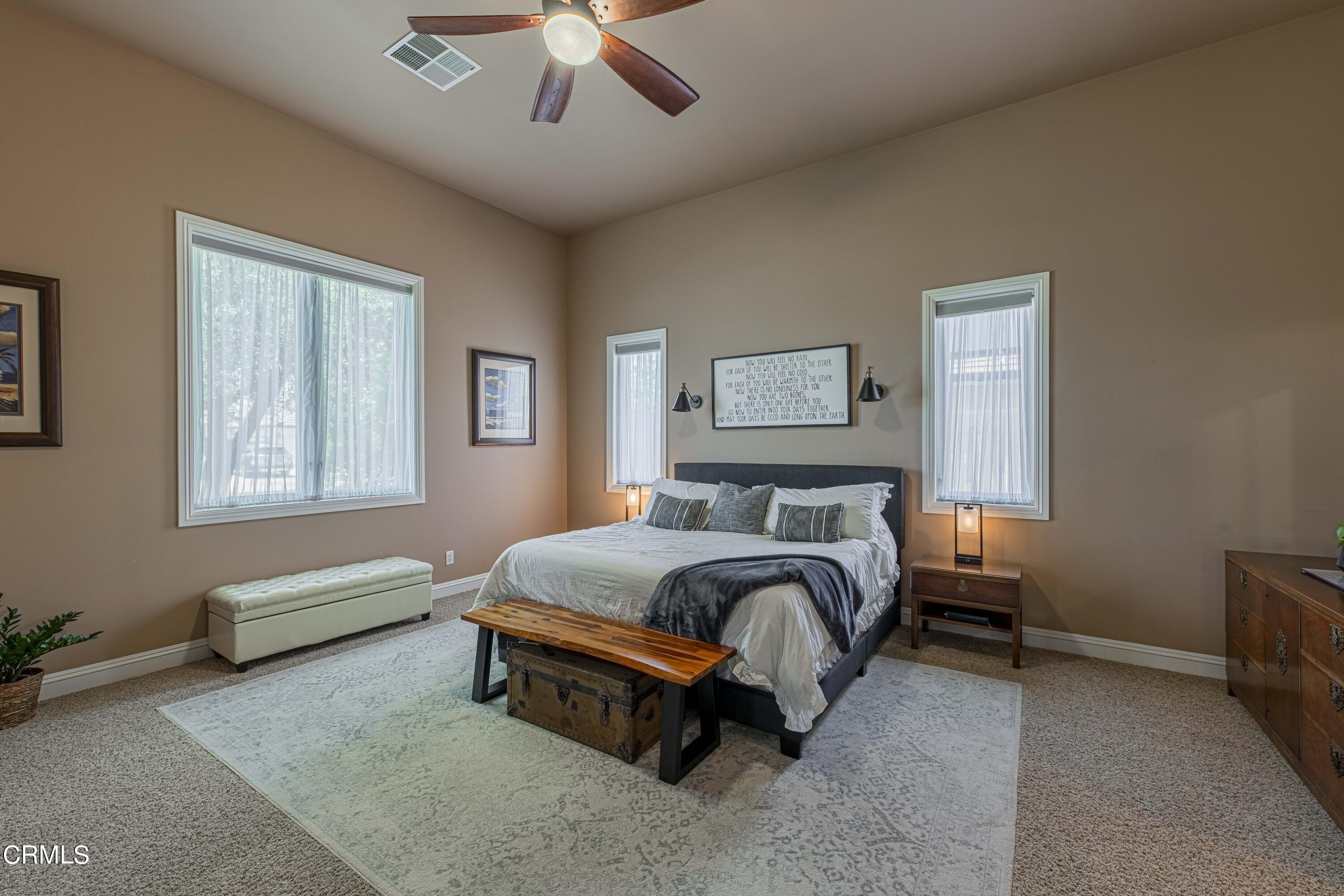 15023 Redwood Pass Drive Bakersfield, CA 93314 - Photo 24 of 67 a bedroom with a bed and a chandelier