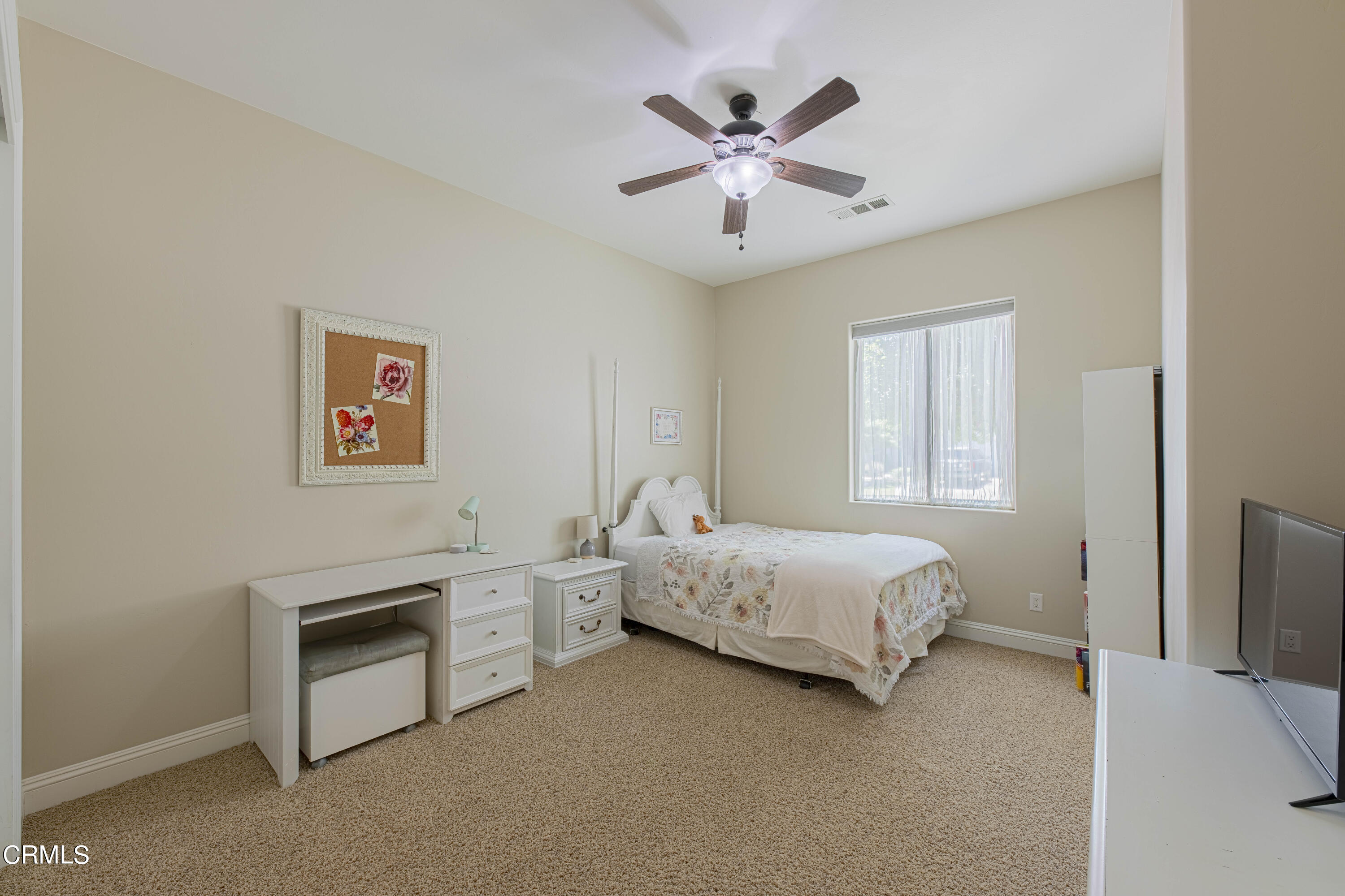 15023 Redwood Pass Drive Bakersfield, CA 93314 - Photo 38 of 67 a spacious bedroom with a bed and a chandelier