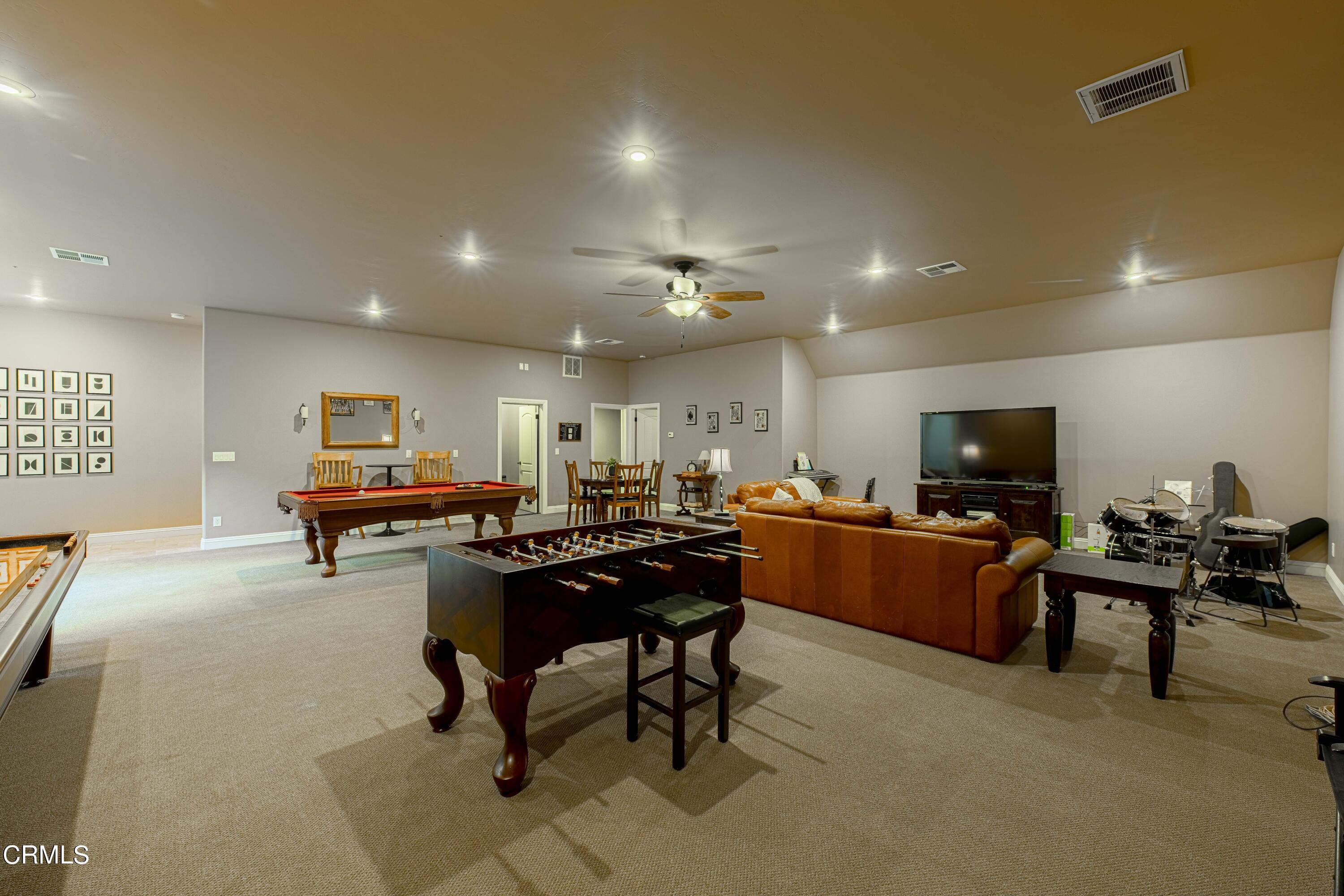 15023 Redwood Pass Drive Bakersfield, CA 93314 - Photo 47 of 67 a room with furniture and a flat screen tv