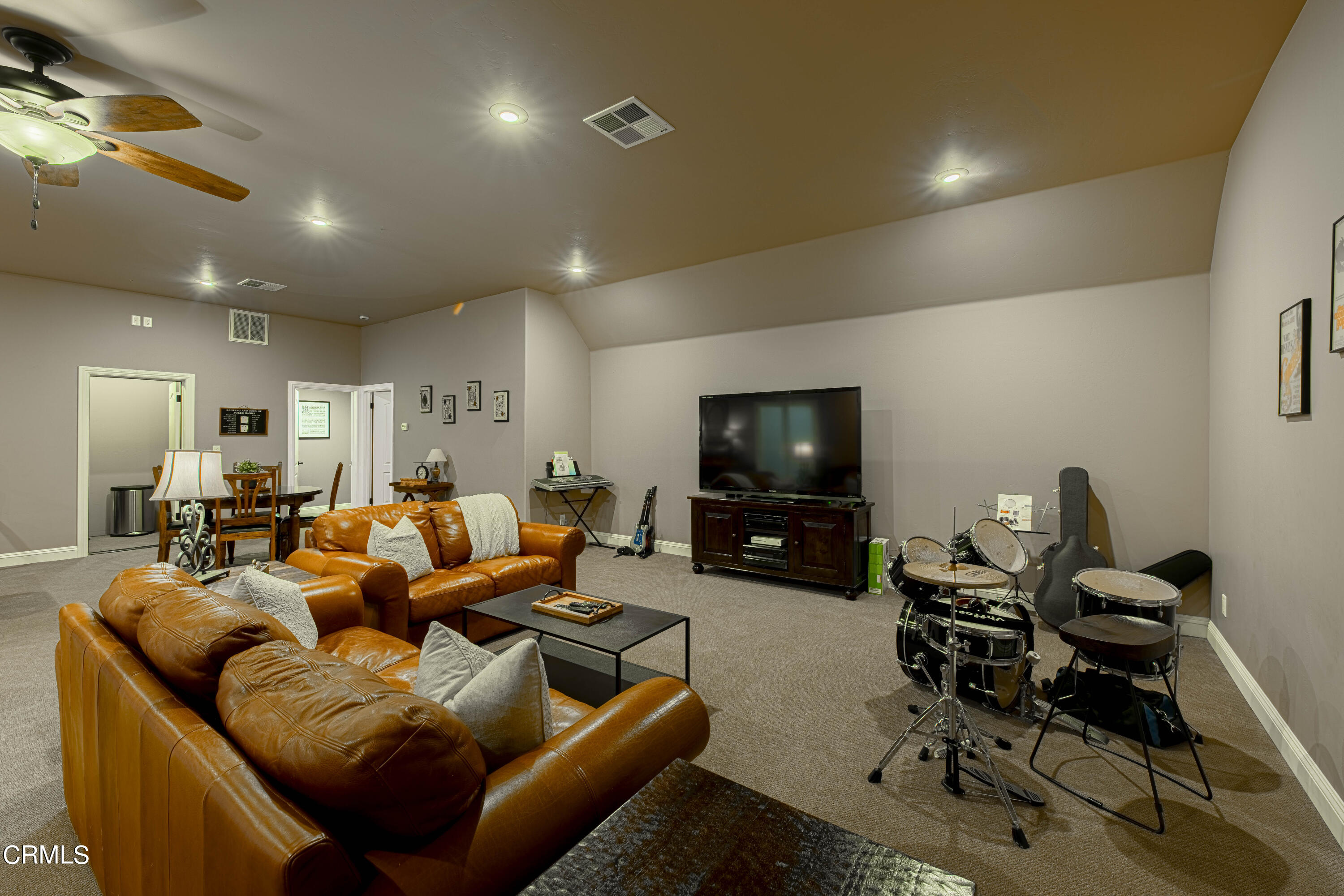 15023 Redwood Pass Drive Bakersfield, CA 93314 - Photo 48 of 67 a living room with furniture a flat screen tv and kitchen view