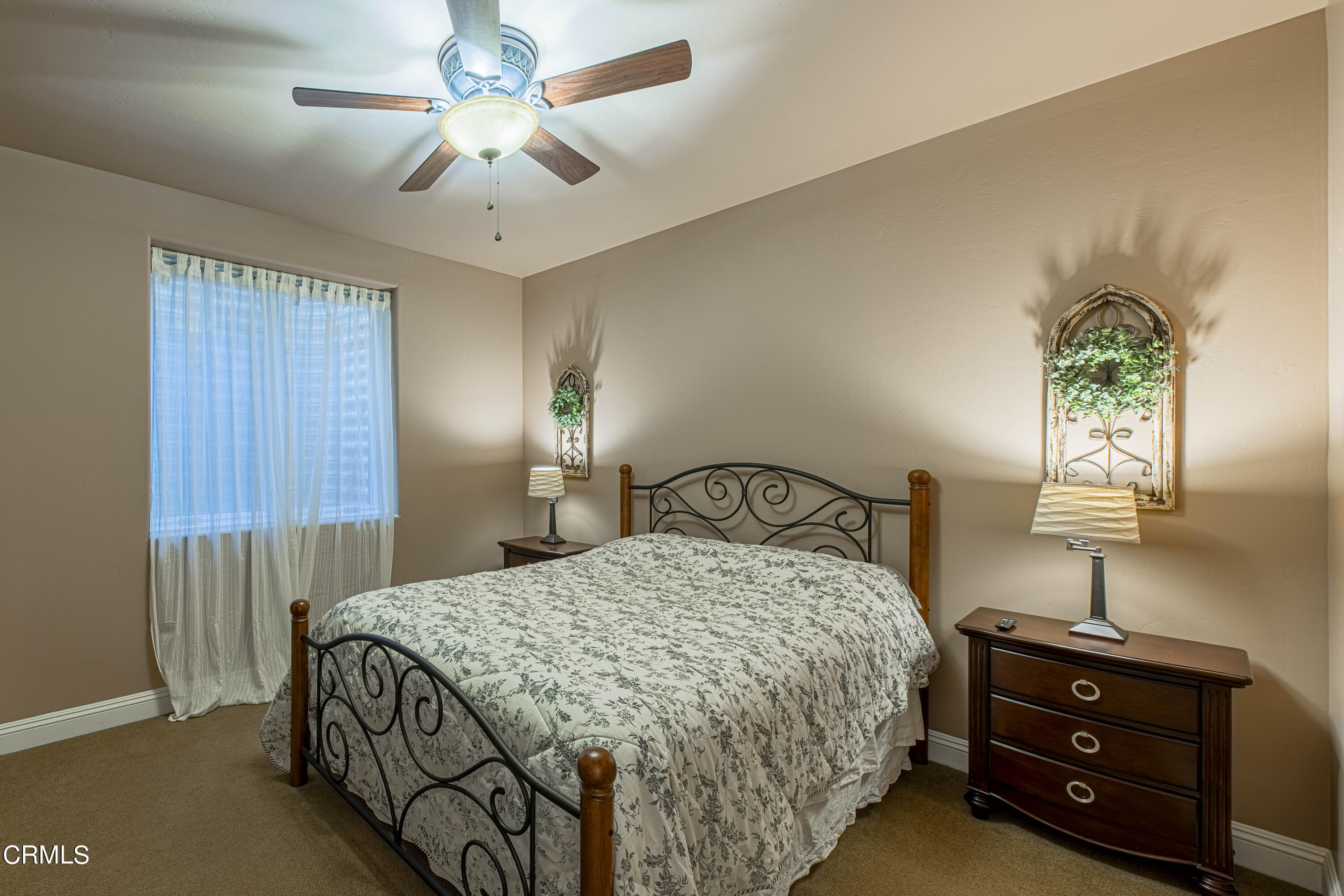 15023 Redwood Pass Drive Bakersfield, CA 93314 - Photo 52 of 67 a bedroom with a bed and a chandelier