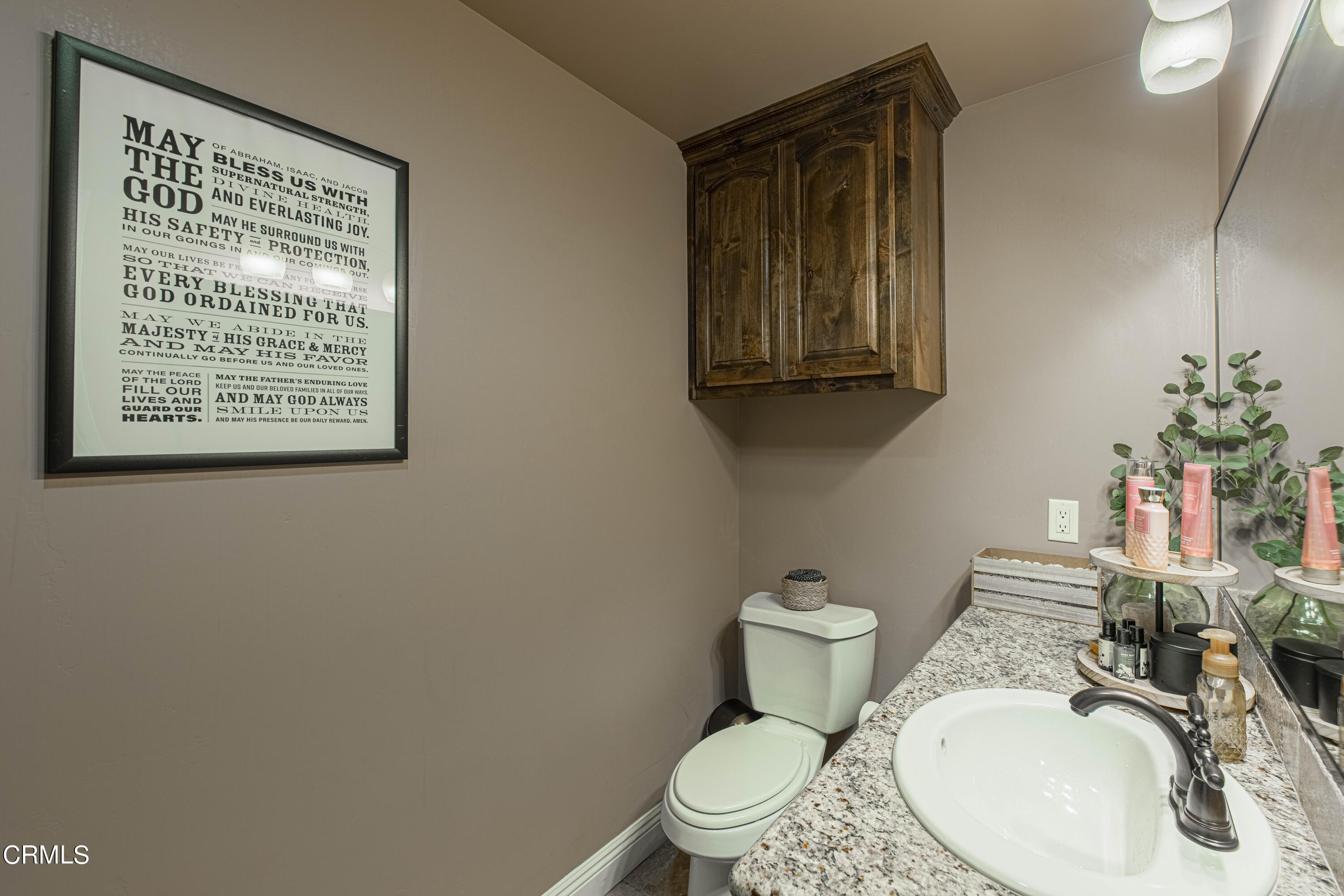 15023 Redwood Pass Drive Bakersfield, CA 93314 - Photo 53 of 67 a bathroom with a toilet a sink and mirror