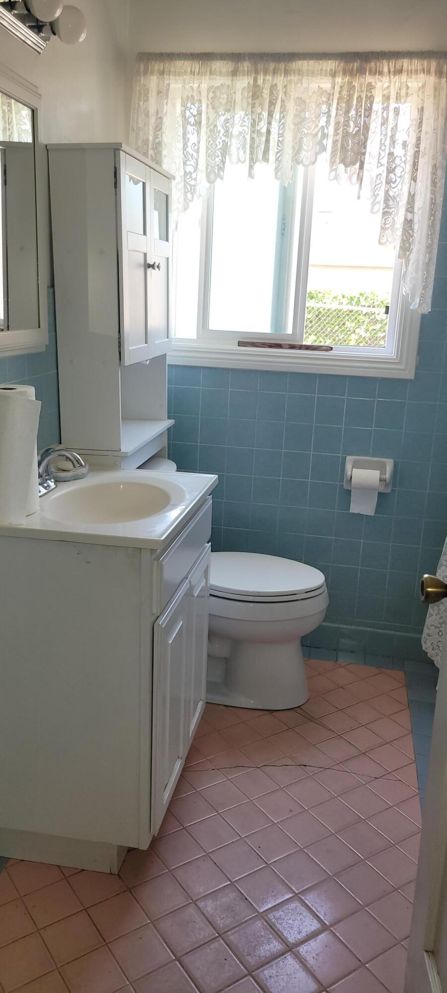 1103 West Bennett Street Compton, CA 90220 - Photo 14 of 20 a bathroom with a sink toilet and window