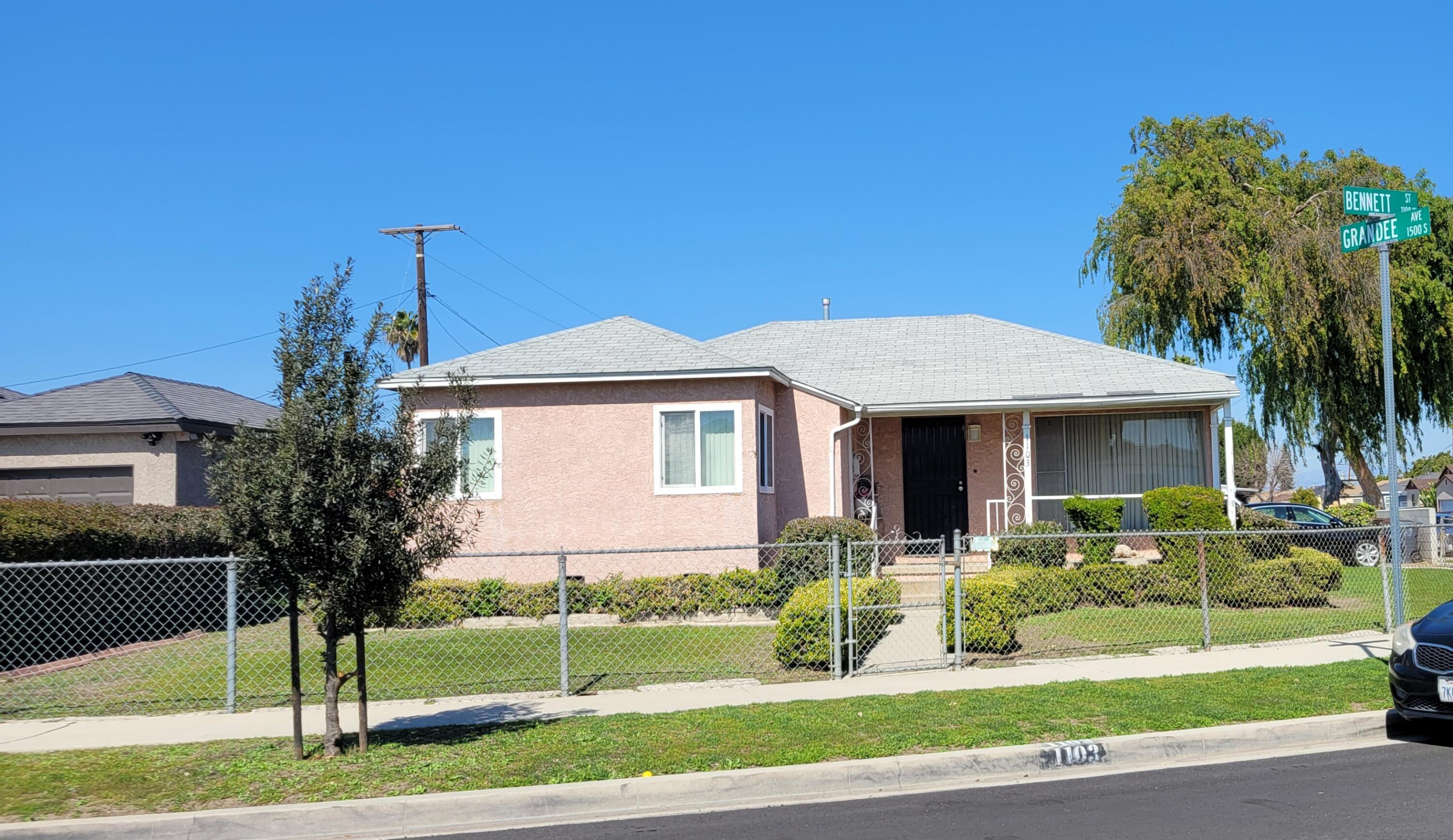 1103 West Bennett Street Compton, CA 90220 - Photo 2 of 20 a front view of a house with a garden and plants