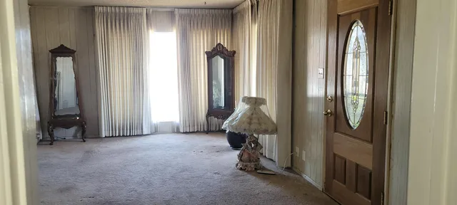 a view of a hallway with furniture and closet