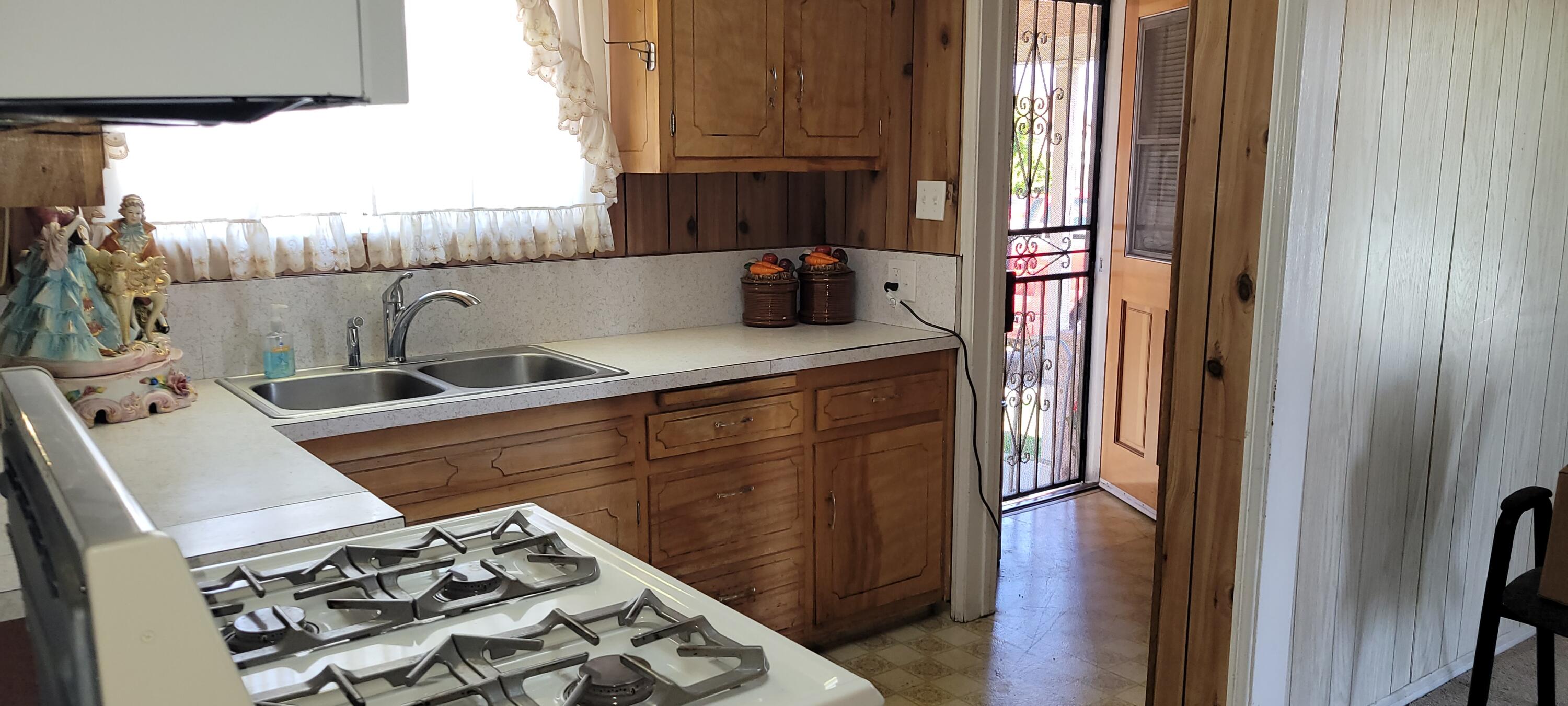 1103 West Bennett Street Compton, CA 90220 - Photo 9 of 20 a kitchen with a sink and a stove top oven