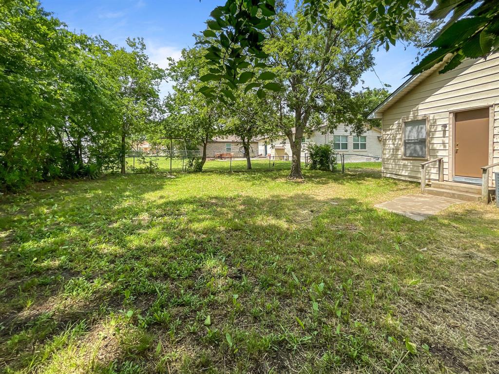 109 South 5th Street Sanger, TX 76266 - Photo 3 of 14 a view of a yard with a tree