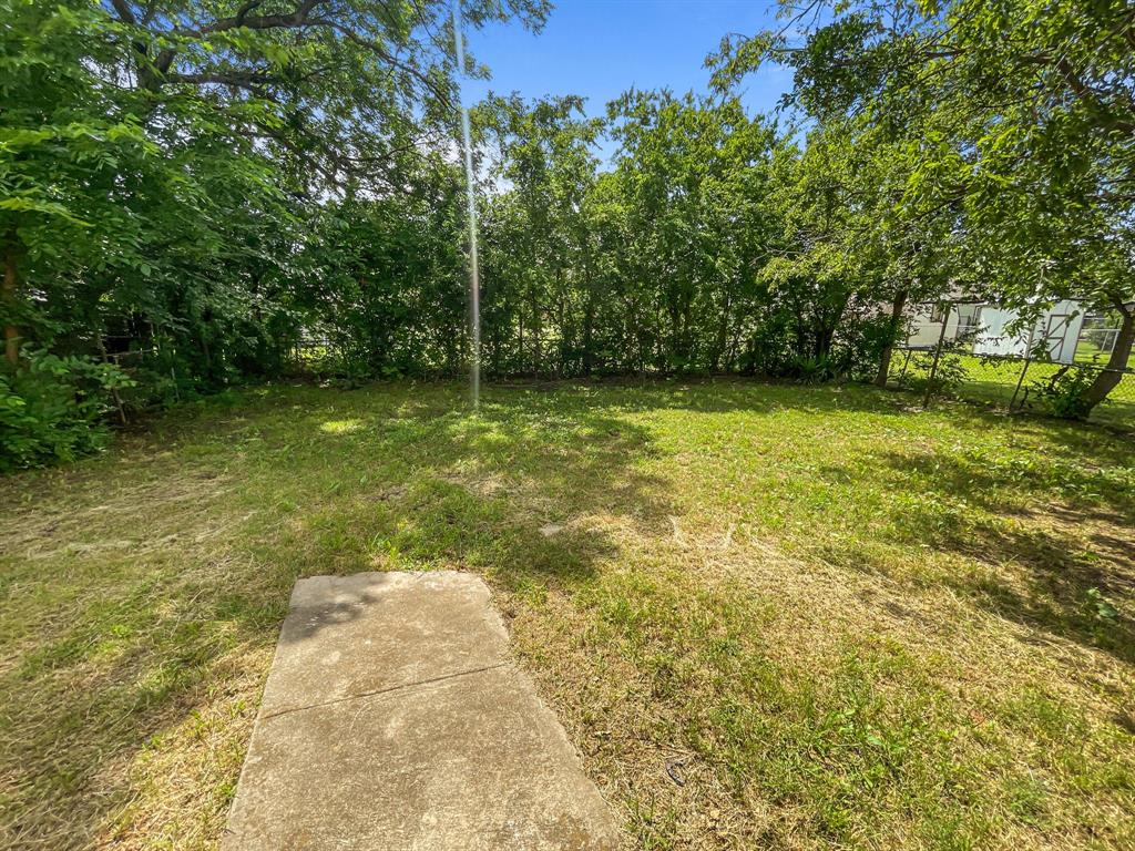 109 South 5th Street Sanger, TX 76266 - Photo 4 of 14 a view of a yard with a trees