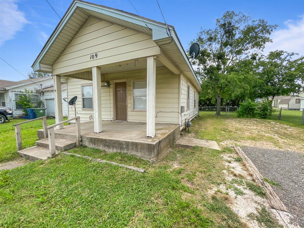 109 South 5th Street Sanger, TX 76266 - Photo 6 of 14 a view of a house with a yard patio and a garden