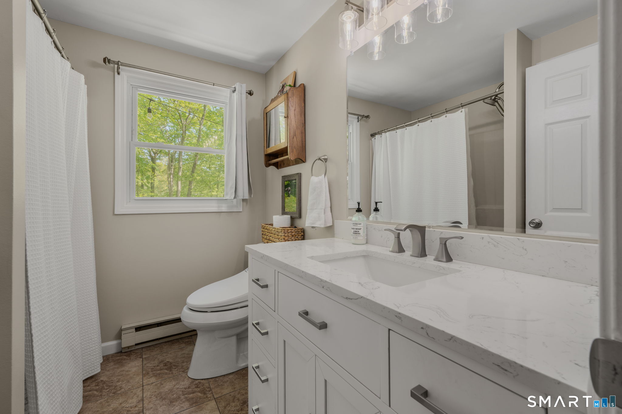 6 Amherst Court Groton, CT 06355 - Photo 15 of 40 a bathroom with a granite countertop toilet a sink a mirror and a window