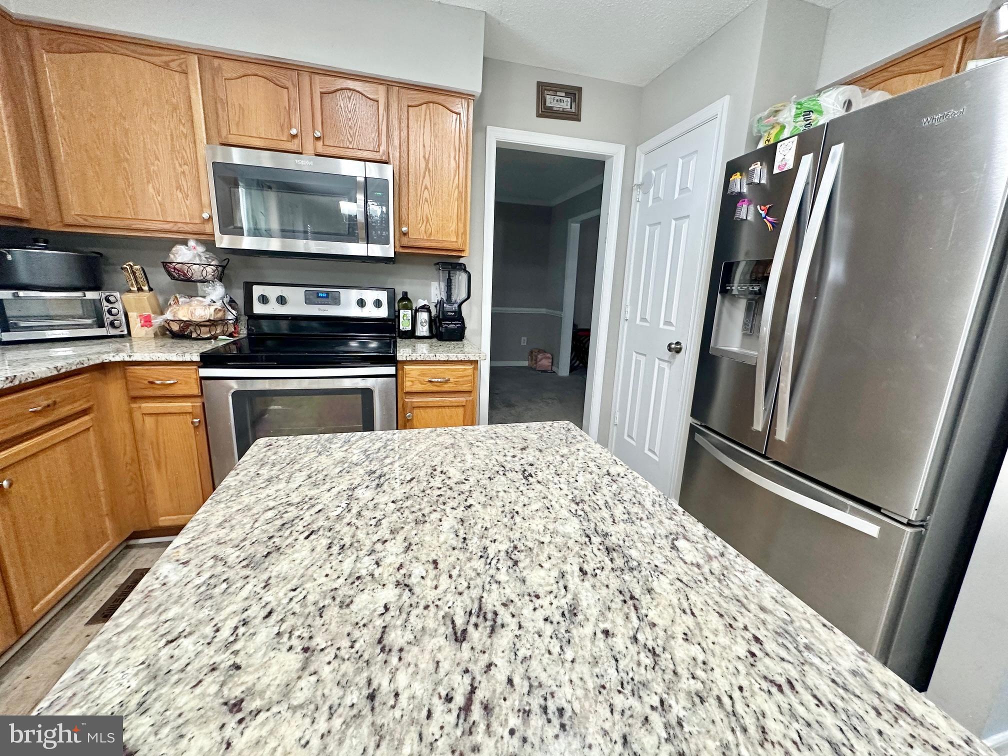 4343 Stately Oak Road North Chesterfield, VA 23234 - Photo 11 of 17 a kitchen with stainless steel appliances granite countertop a refrigerator stove and microwave