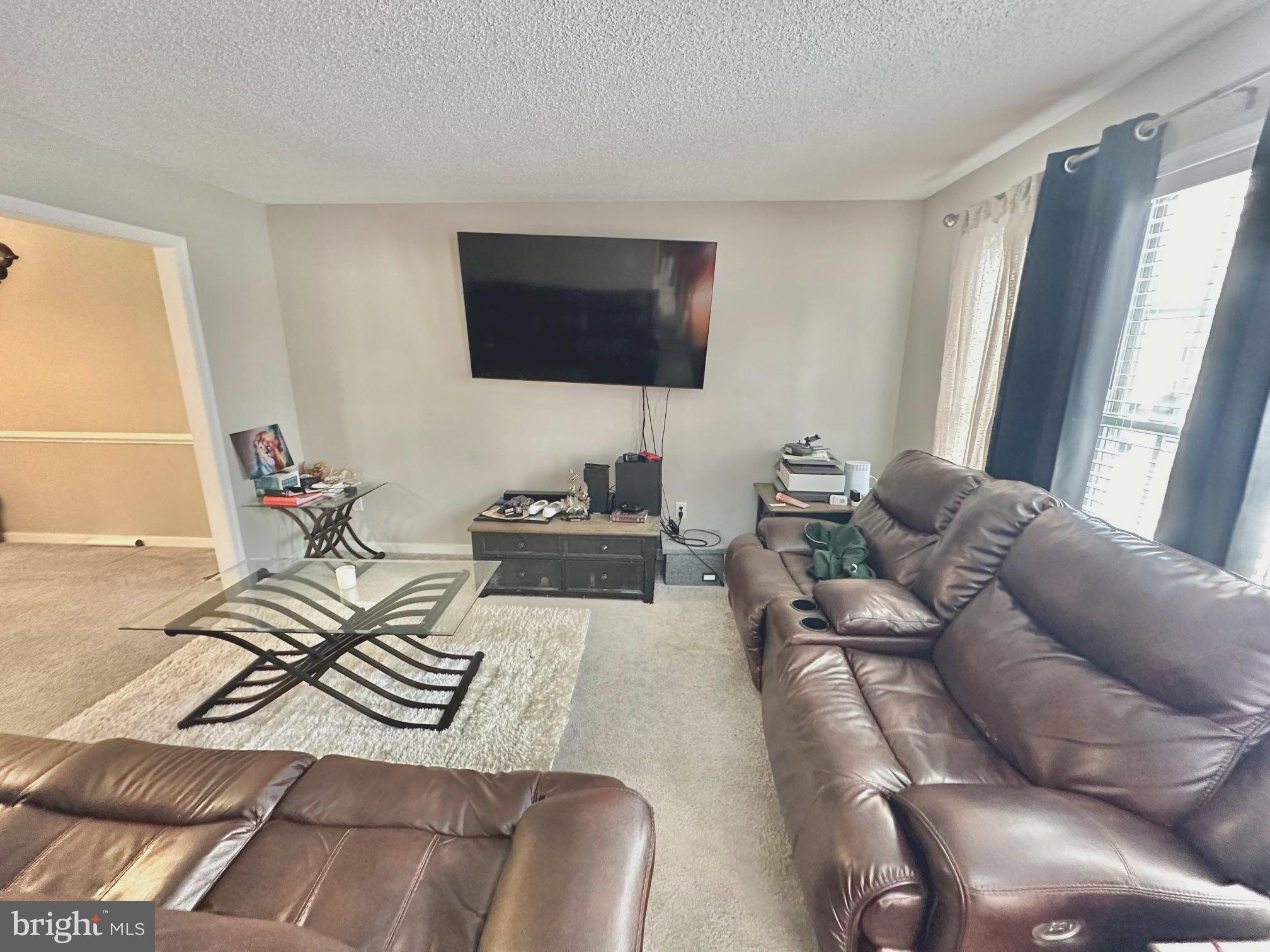 4343 Stately Oak Road North Chesterfield, VA 23234 - Photo 6 of 17 a living room with furniture a flat screen tv and a window