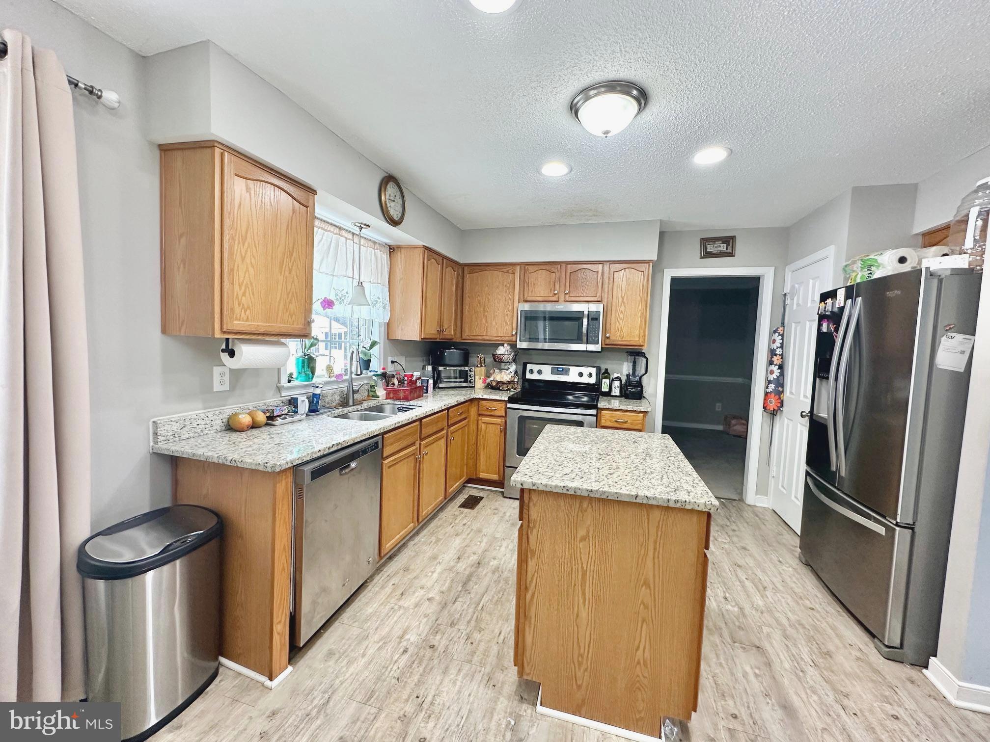 4343 Stately Oak Road North Chesterfield, VA 23234 - Photo 9 of 17 a kitchen with stainless steel appliances granite countertop a refrigerator a sink dishwasher stove and oven