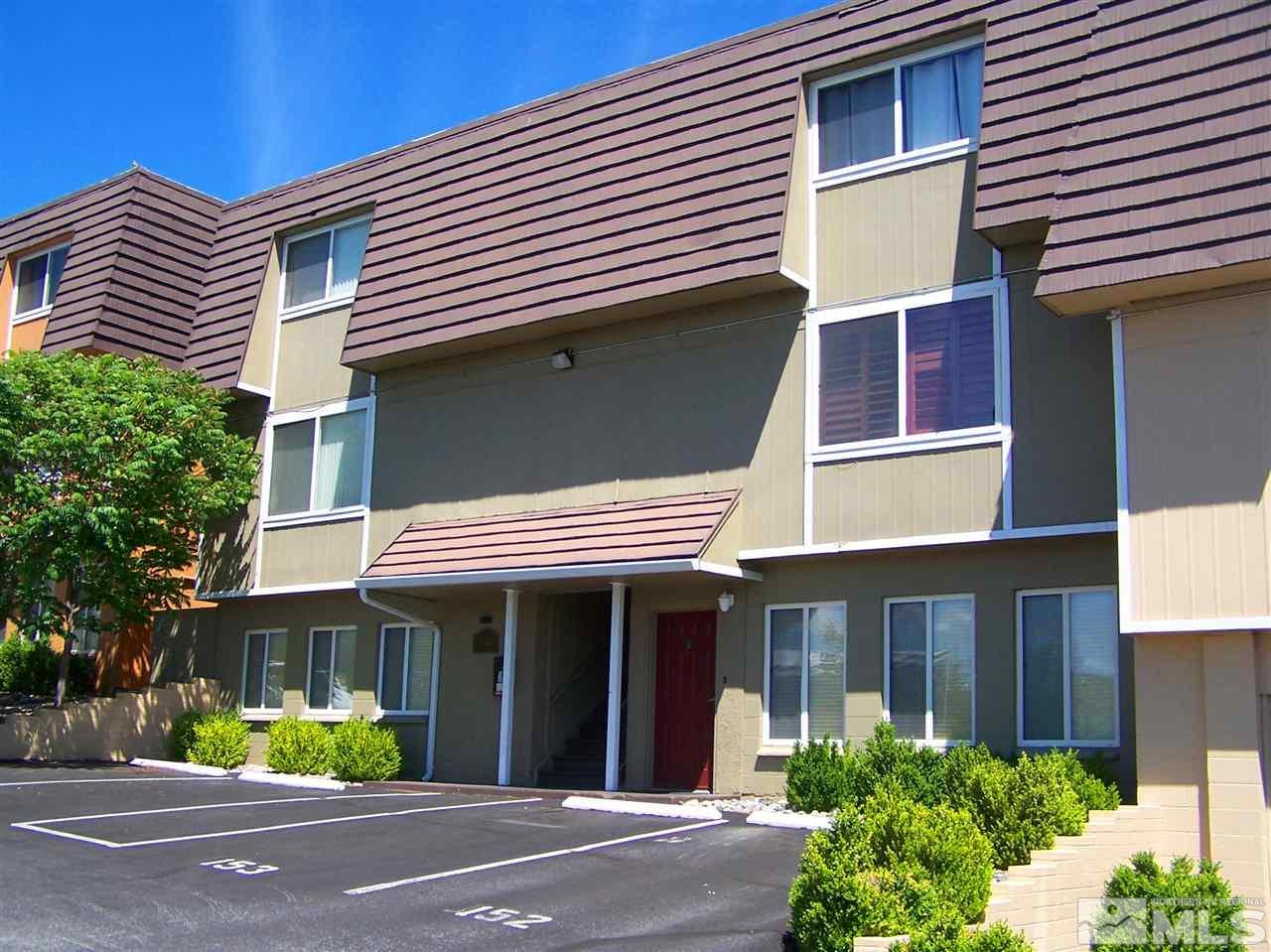 140 Griswold Way, Unit A Reno, NV 89503 - Photo 1 of 1 a view of a white house with a large windows and plants
