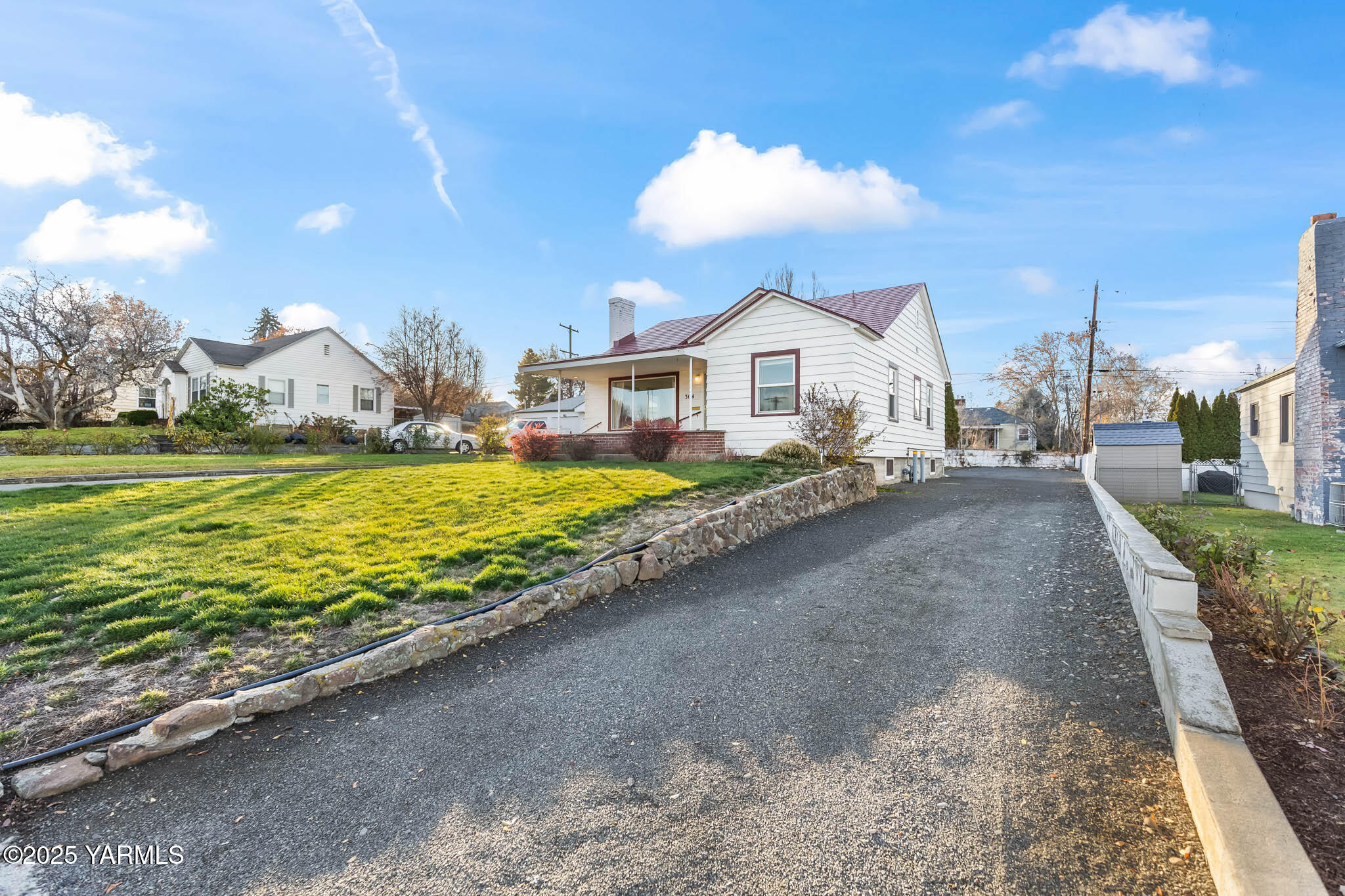 304 North 35th Avenue Yakima, WA 98902 - Photo 30 of 31 a view of a house with a yard and a large tree