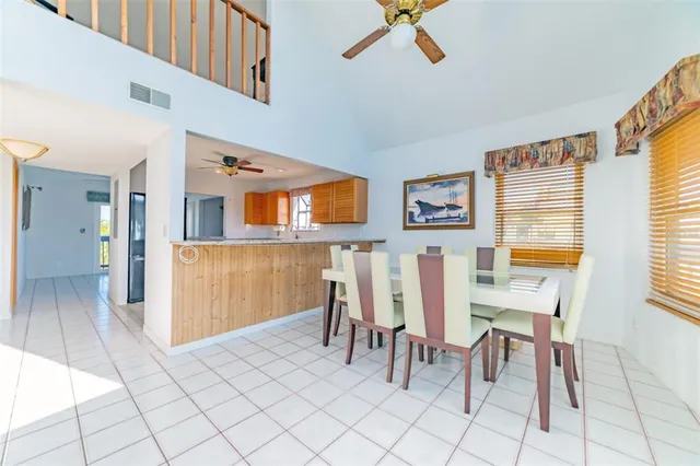 a dining room with furniture and a floor to ceiling window