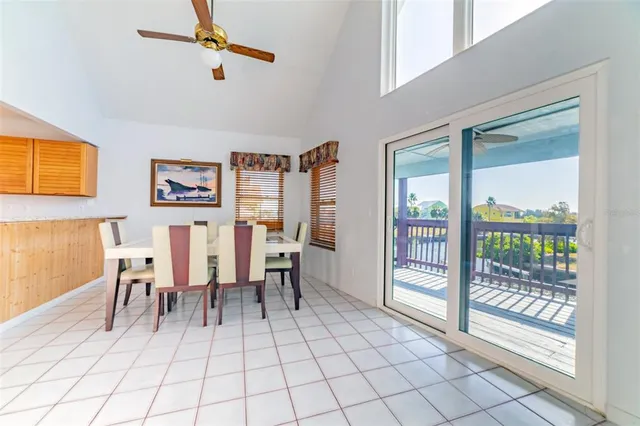 a view of living room filled with furniture and large windows