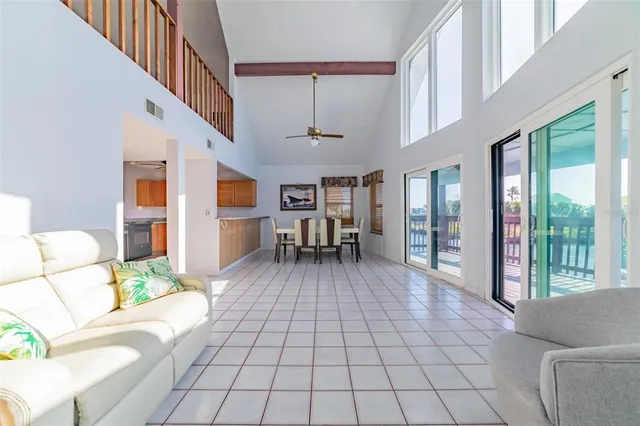 a living room with furniture and a floor to ceiling window